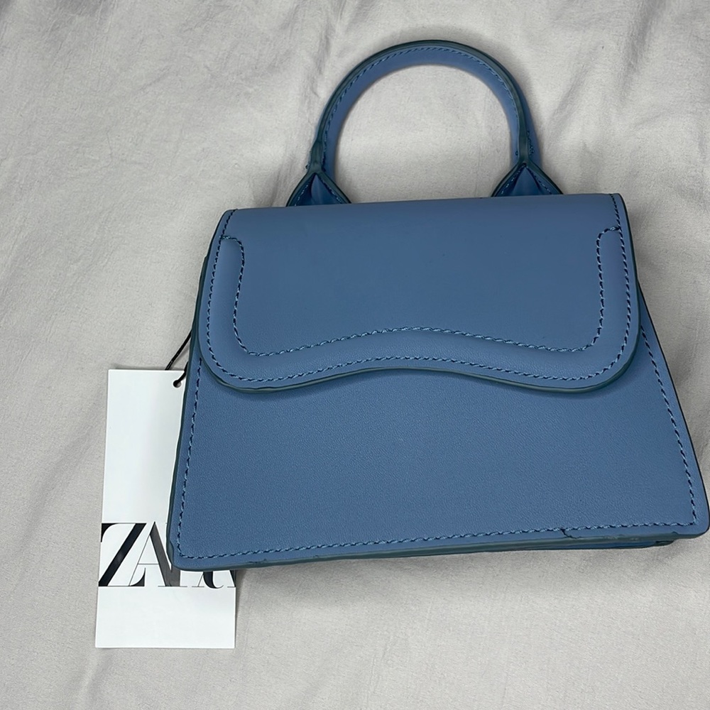 Height x length x width= 5.3 x 6.6 x 3.1 inches. Never worn. Still new with tags